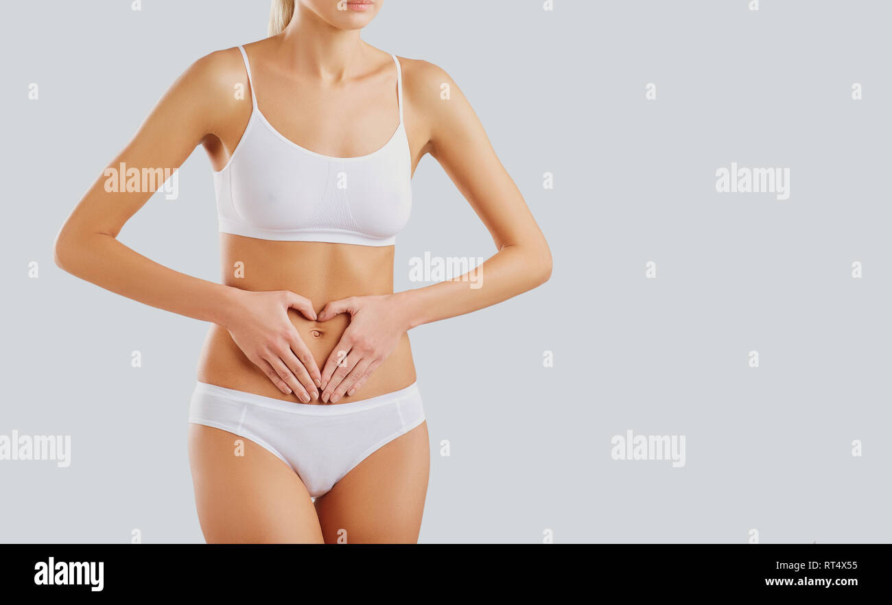 Woman's hands on the stomach Stock Photo