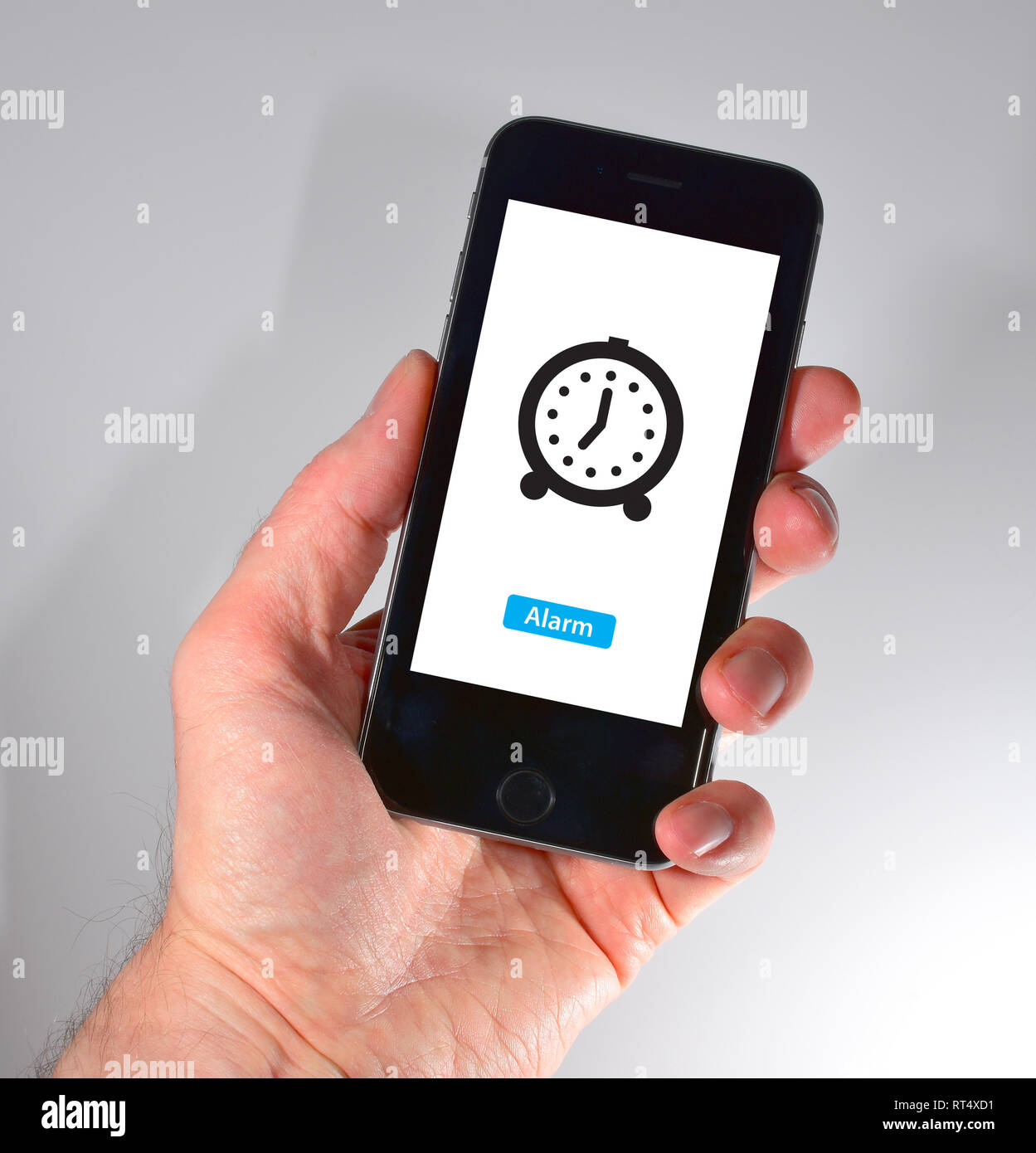 iPhone held in hand alarm symbol Stock Photo Alamy