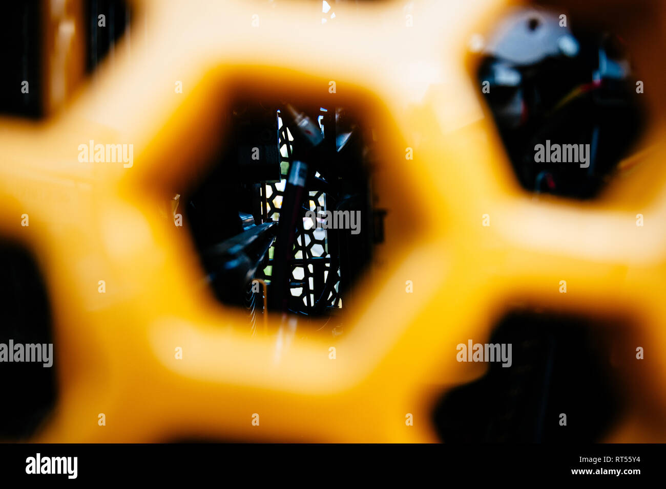 View through metallic grill tractor part painted in yellow with