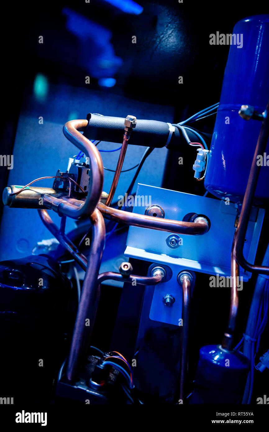 Interior in blue color cast of the AC air conditioning system unit tubes and pipes Stock Photo