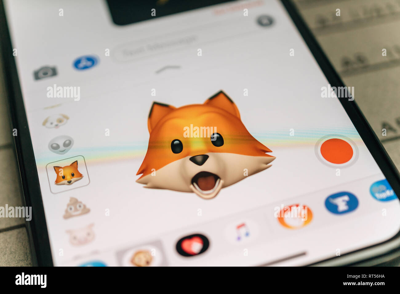 PARIS, FRANCE - NOV 9 2017: Fox animal 3d animoji emoji generated by Face ID facial recognition system with wow astonished face emotion close-up of the new iphone X 10 Display - tilt-shift lens used  Stock Photo