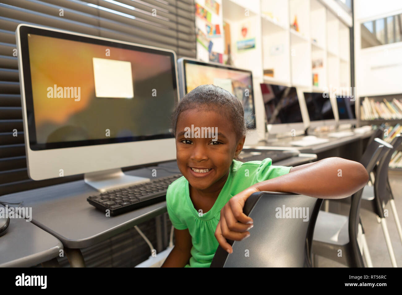 Schoolgirl sitting in the library at school Stock Photo - Alamy