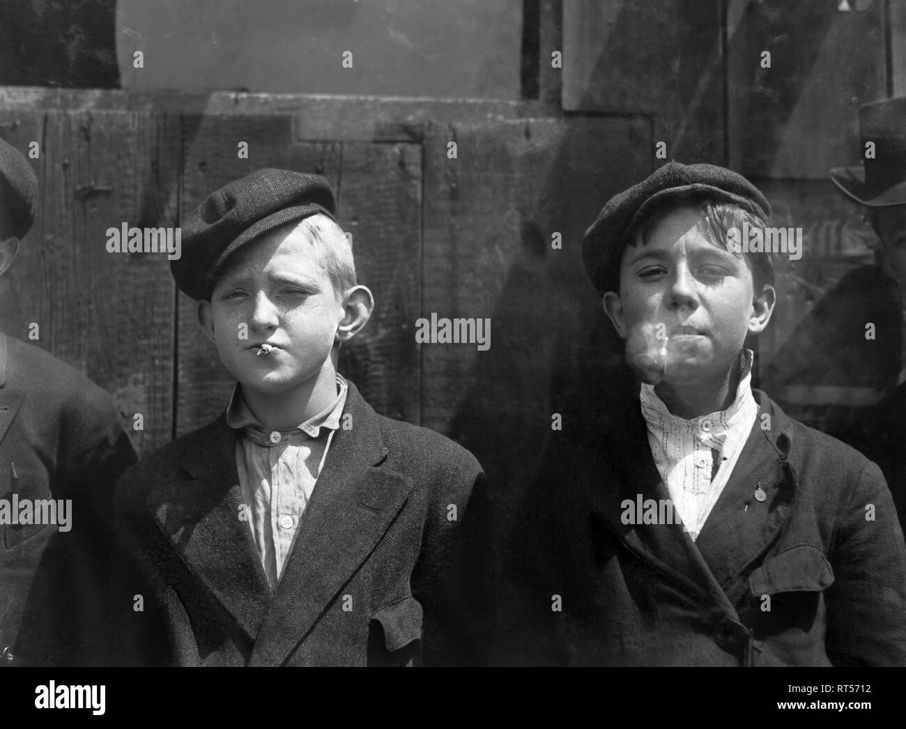 May 9, 1910 - Young newsboys smoking on a St. Louis, Missouri street. Stock Photo