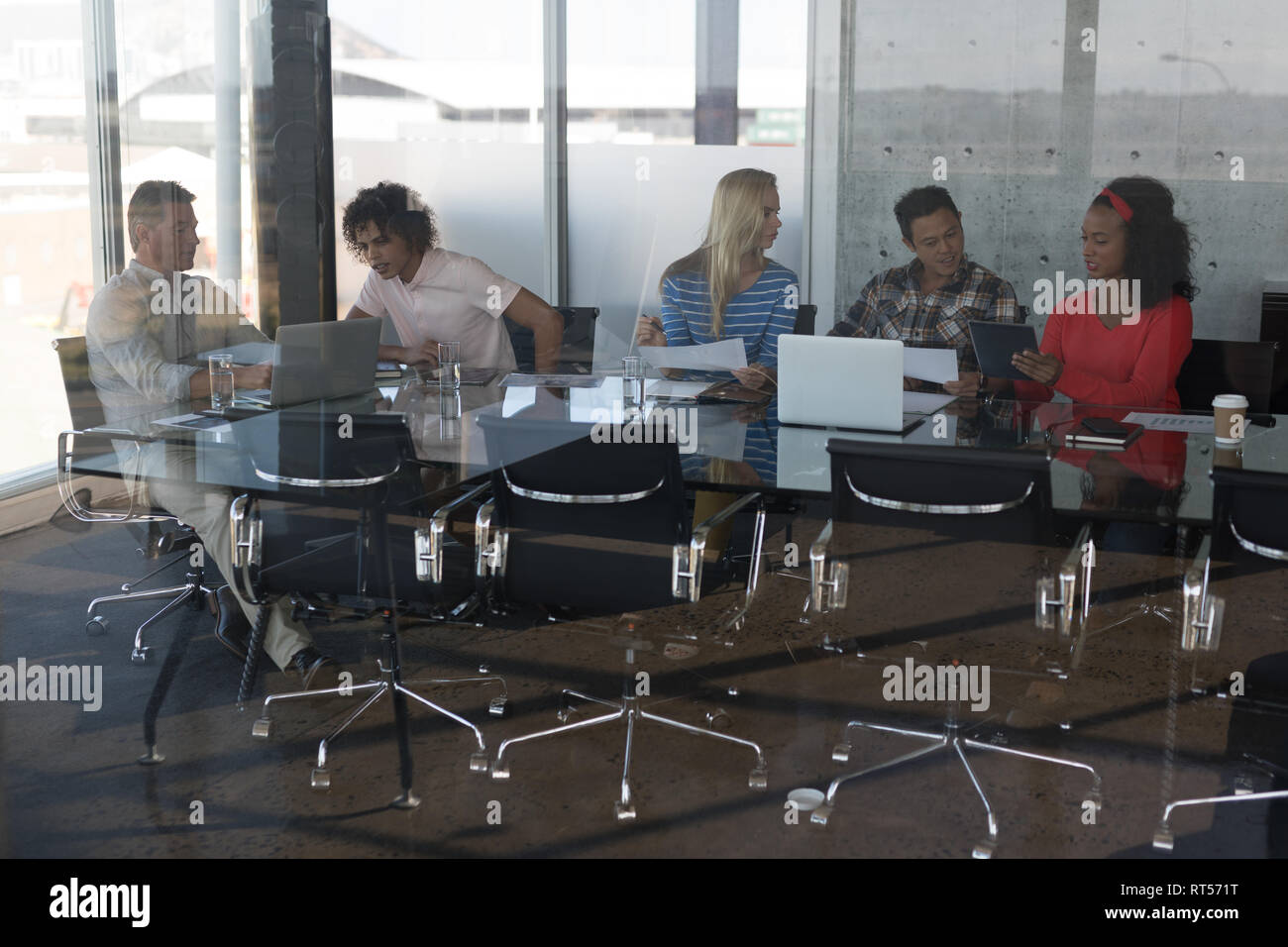 Executives working at table in office Stock Photo