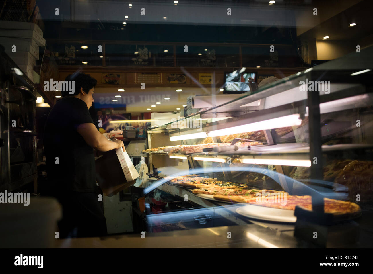 New York City, NY - March 25, 2017: Unidentified person buying things at a food shop in New York City, NY Stock Photo