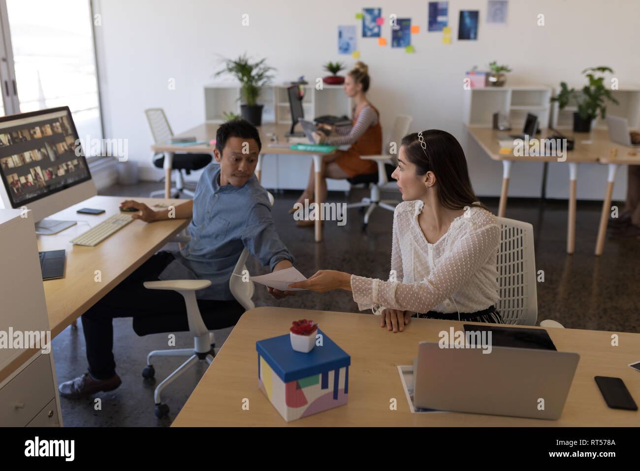Business colleagues discussing over document in office Stock Photo
