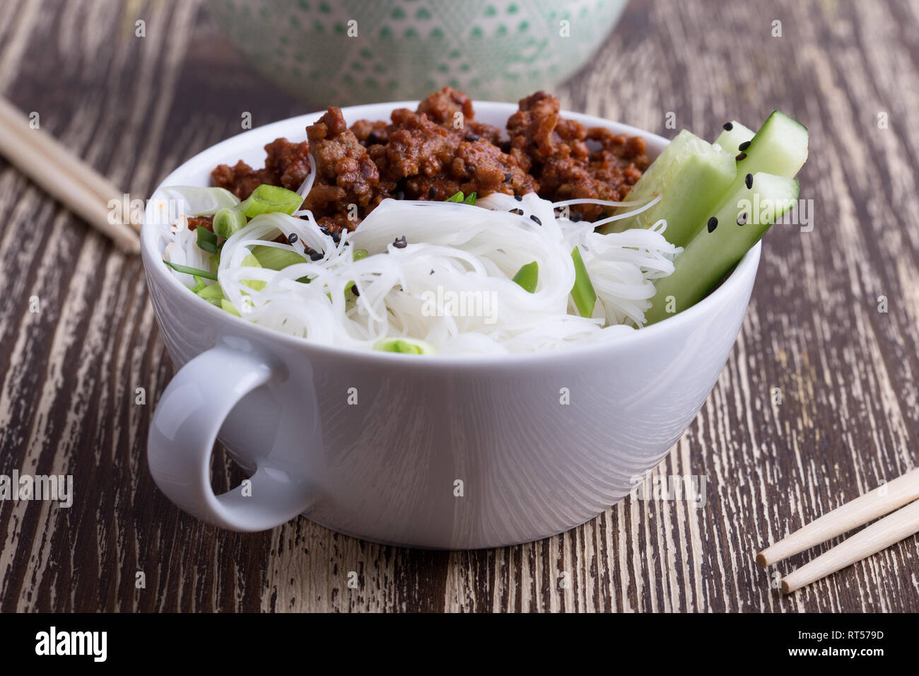 asian-style-bowl-with-ground-beef-rice-noodles-cucumber-green-onions