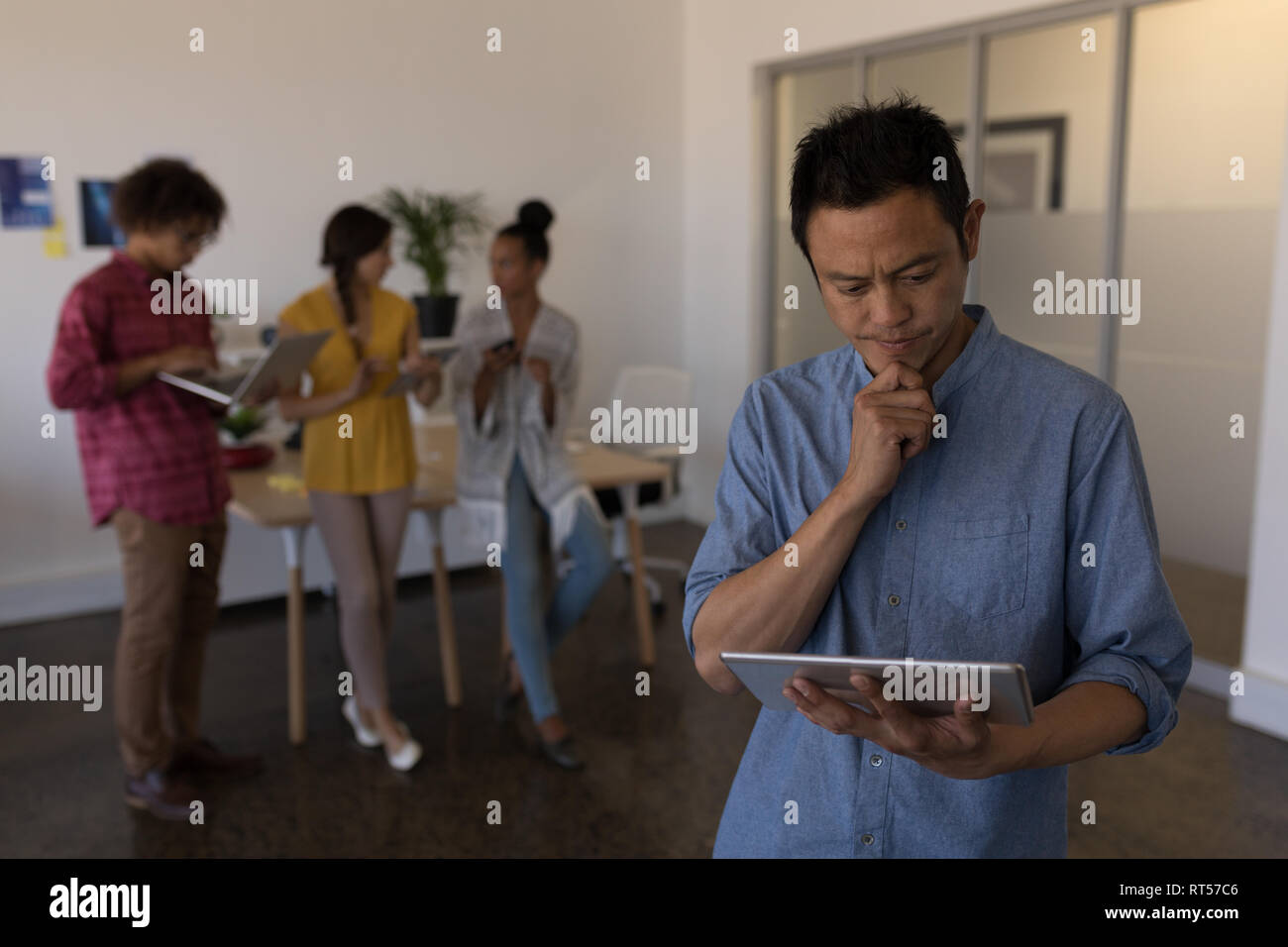 Male executive using digital tablet in office Stock Photo