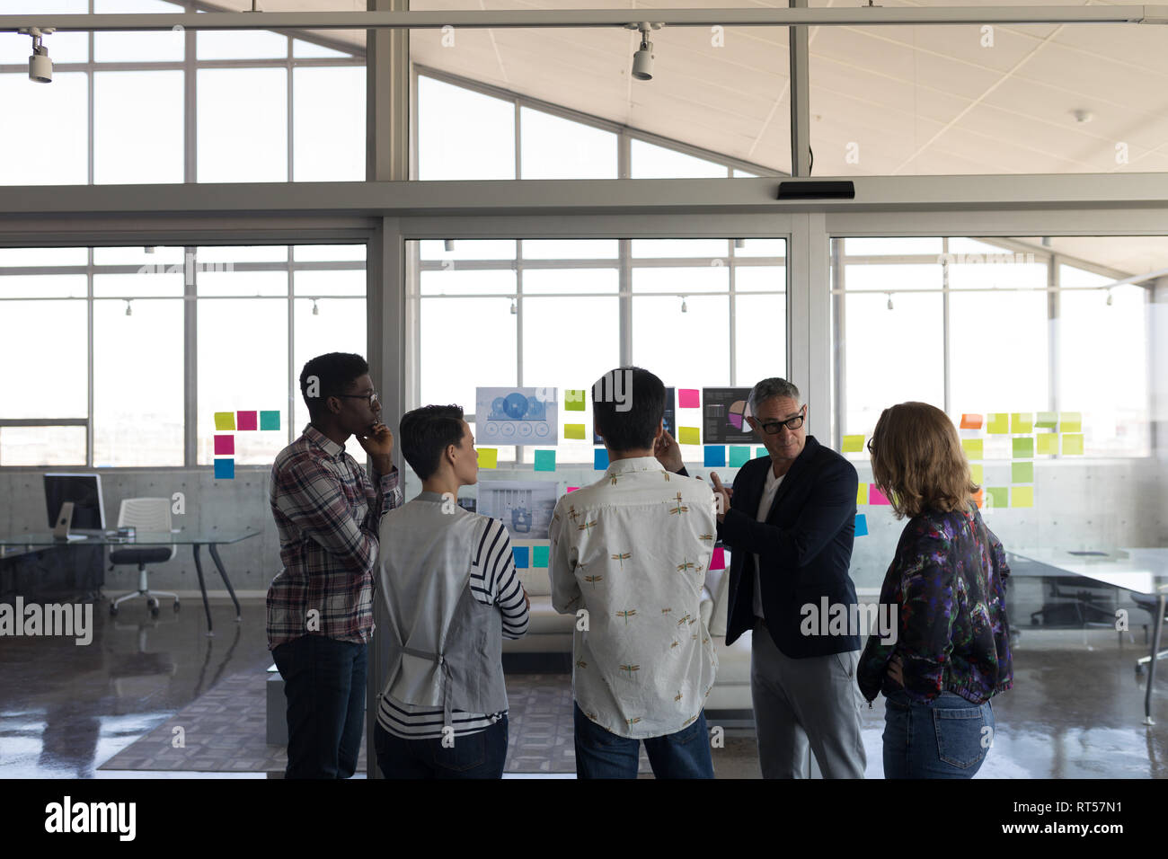 Business colleagues discussing over chart in office Stock Photo