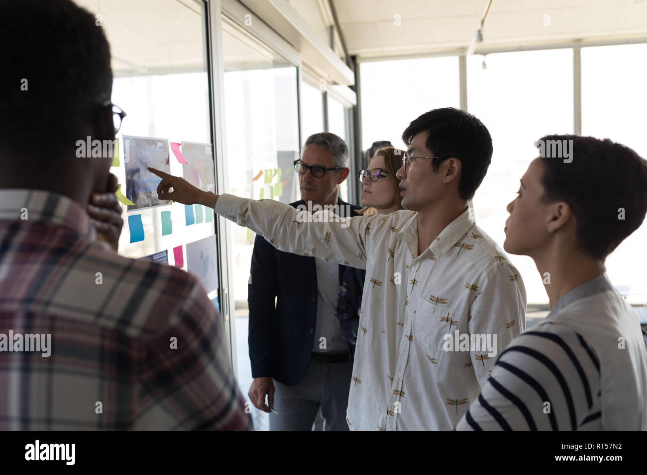 Business colleagues discussing over chart in office Stock Photo