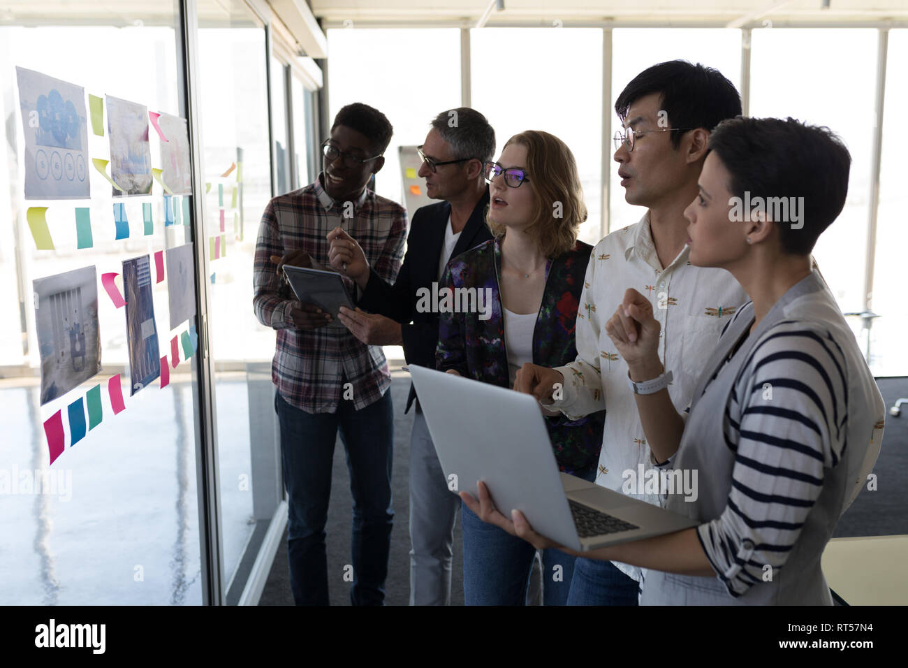 Business colleagues discussing over chart in office Stock Photo