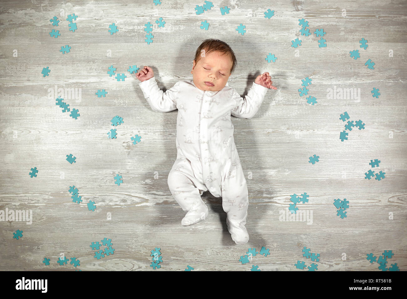 Newborn Baby Quietly Sleeps On A Wooden Floor Blue Puzzles Around