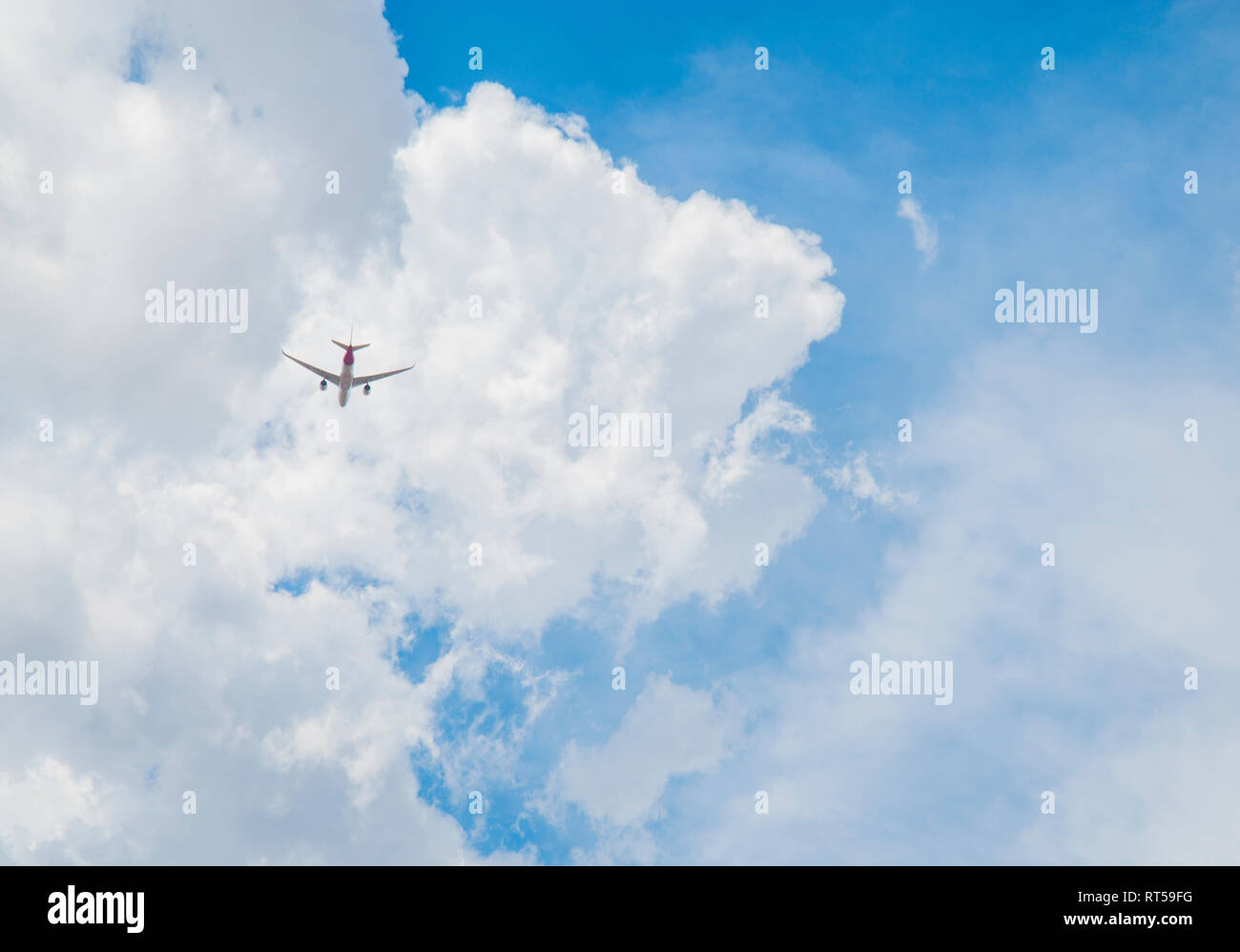 Airplane flying on cloudy sky. Stock Photo