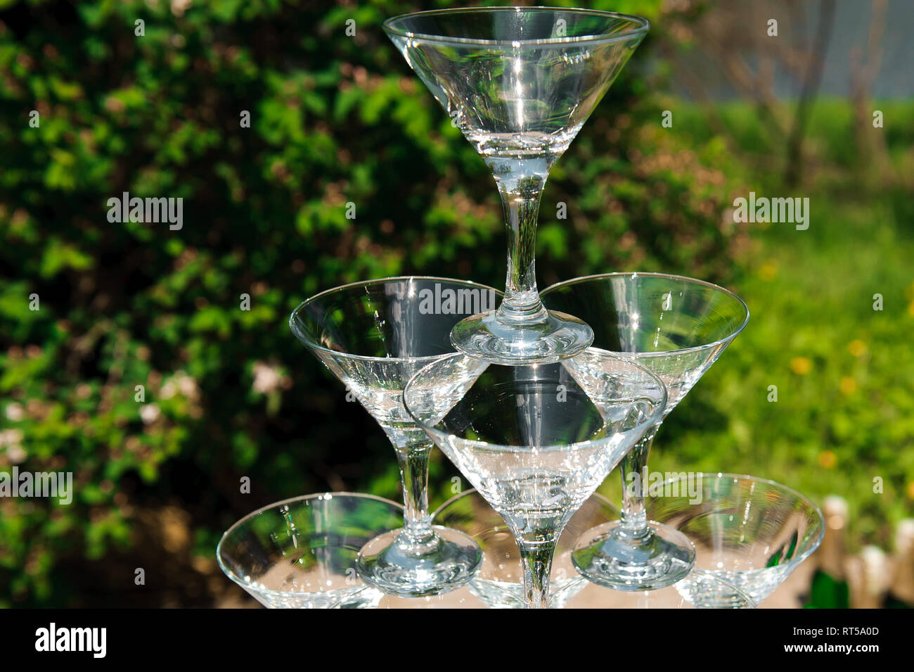 Pyramid of glasses of champagne. hill. Pyramid of champagne outdoors in