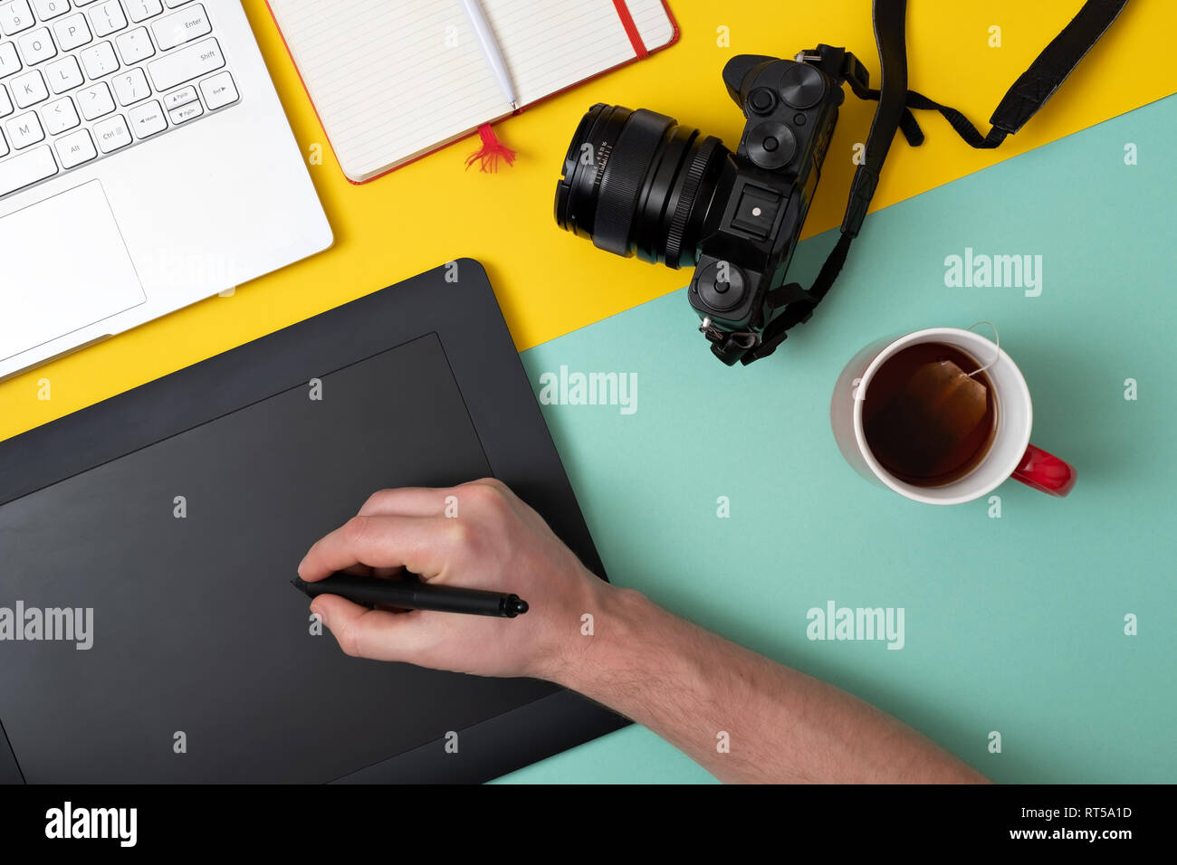 Designer using graphic tablet in digital work and photo editing. Top flat lay view Stock Photo
