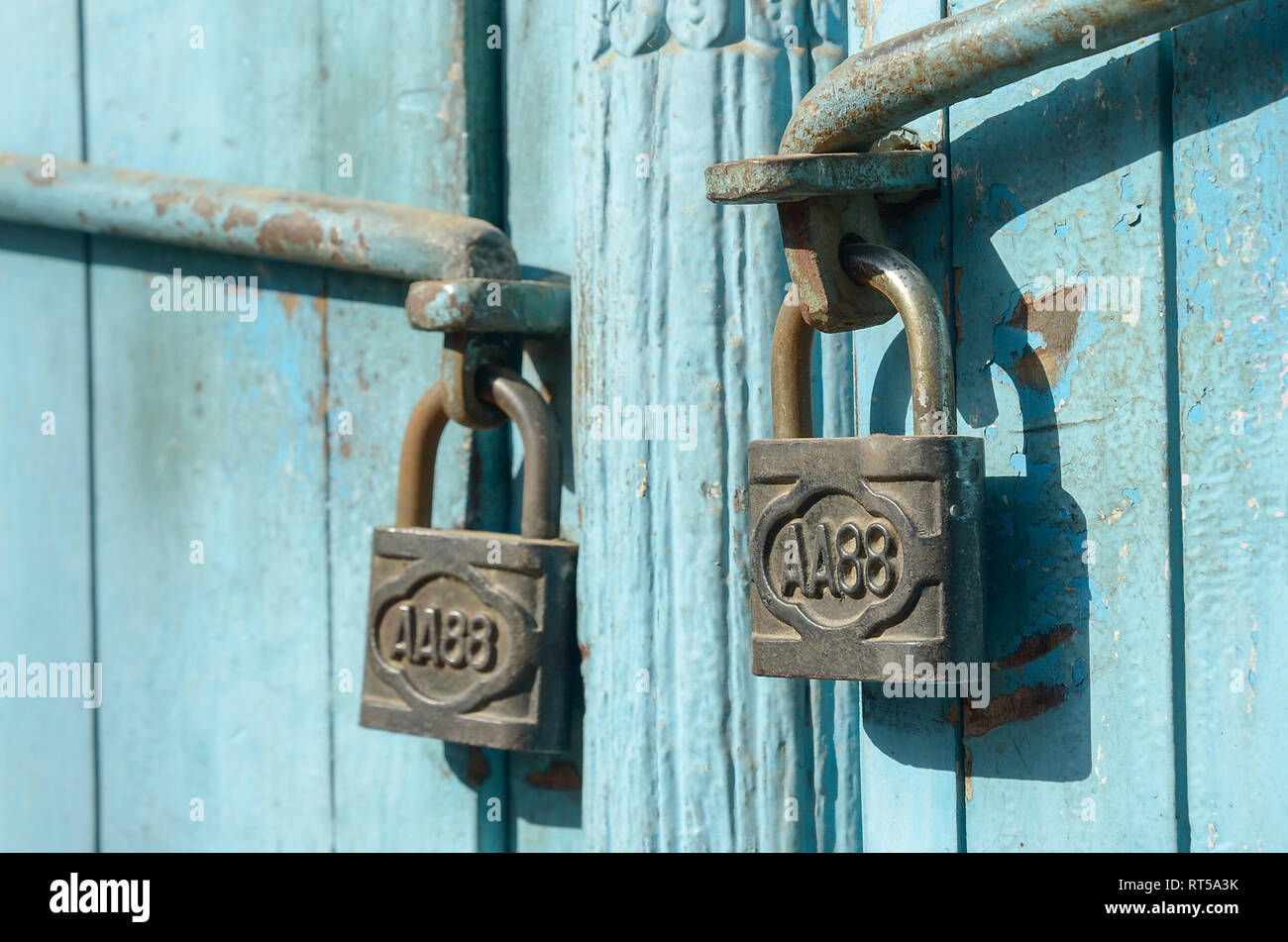 Padlocks locking a blue door or gate Stock Photo Alamy
