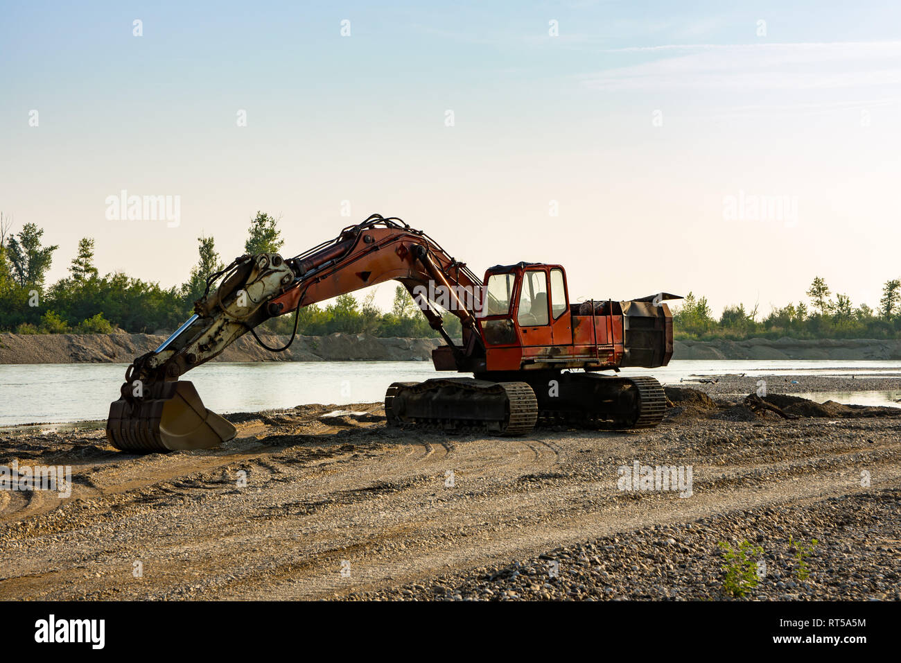 Bulldozer dredger, digs sand on the bank of the river Drina Stock Photo