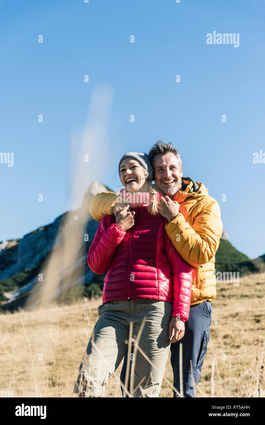 Austria, Tyrol, happy couple embracing on a hiking trip in the mountains Stock Photo