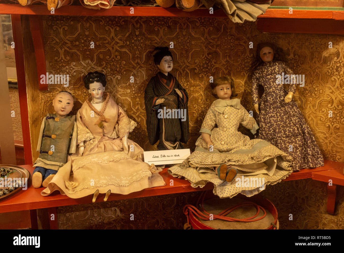 Window displays of the latest dolls in the Kendrick's Toy Dealers and Fancy Repository shop, Kirkgate, in the York Castle Museum, York, Yorkshire, UK. Stock Photo
