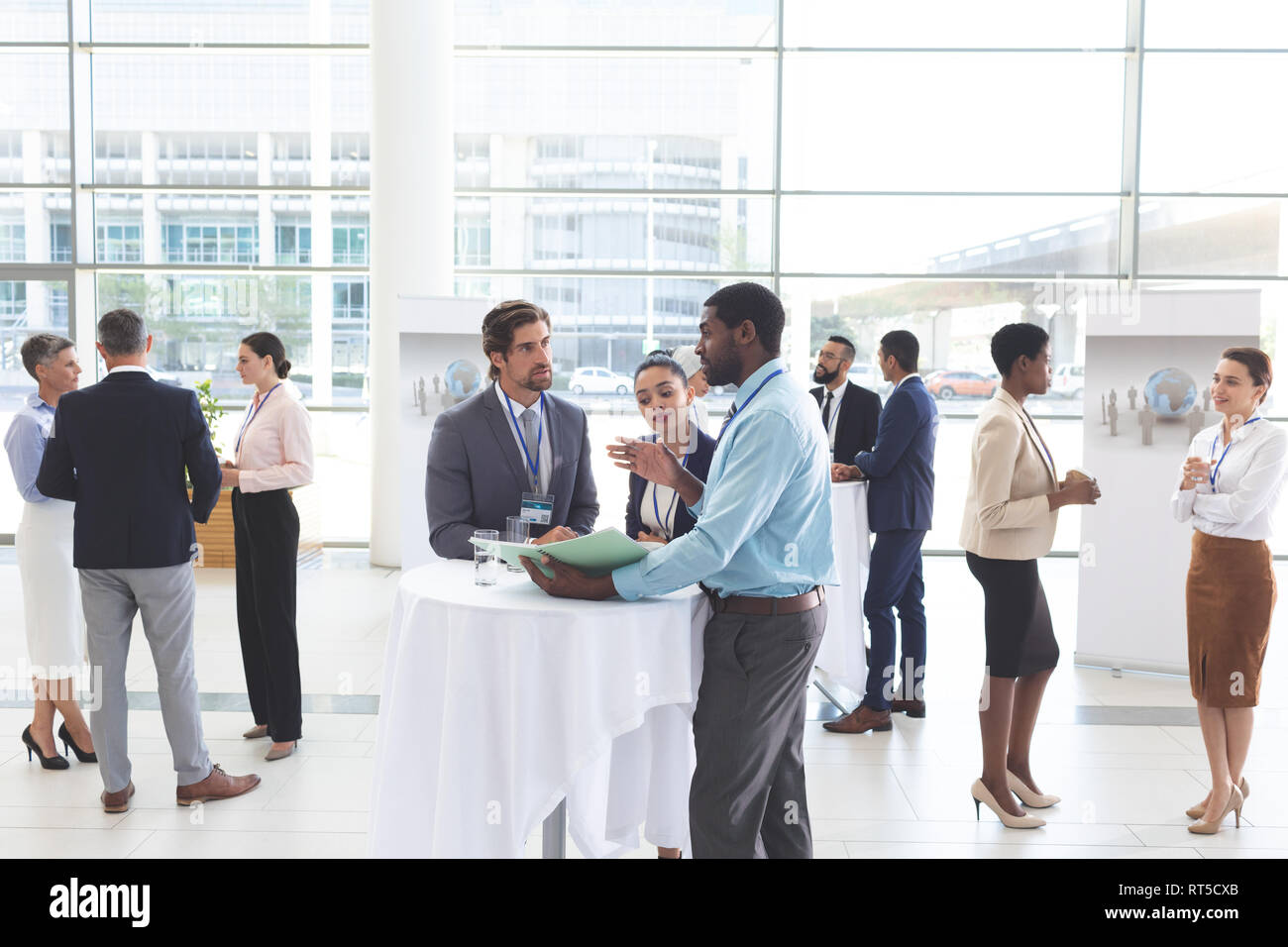 Business people discussing over documents at table during a seminar Stock Photo