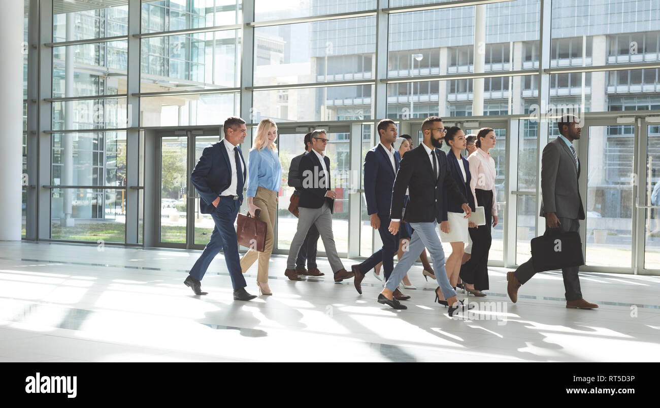 Group of diverse business people walking together in lobby office Stock ...