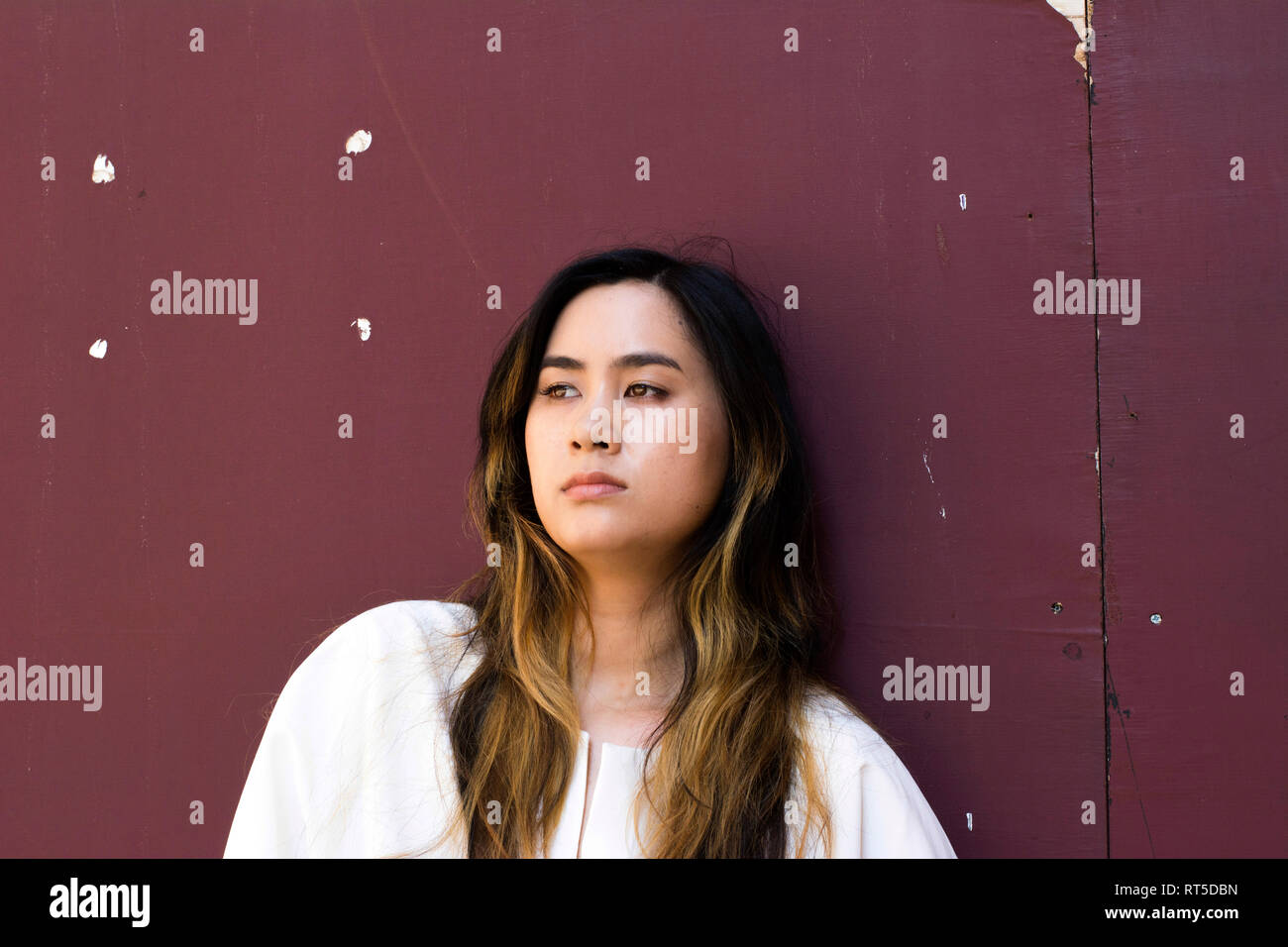 Portrait of serious young woman looking at distance Stock Photo - Alamy