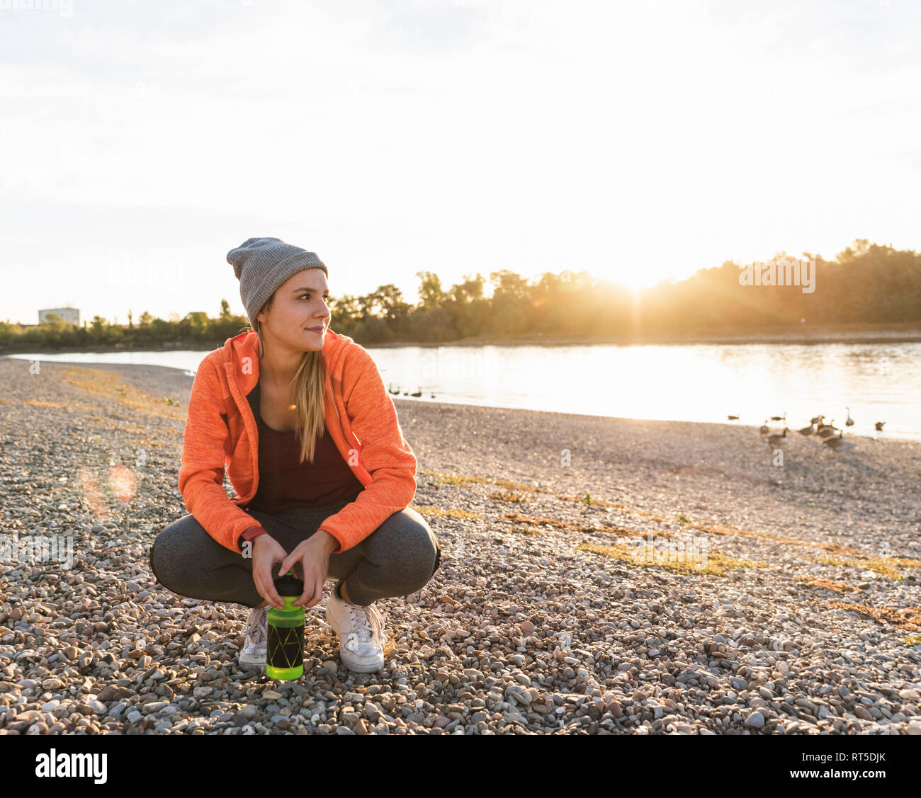 Sportive woman taking a break at the river Stock Photo