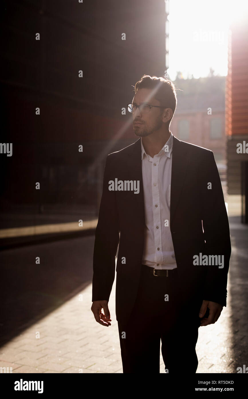 Stylish businessman in suit on sunny city street hi-res stock ...