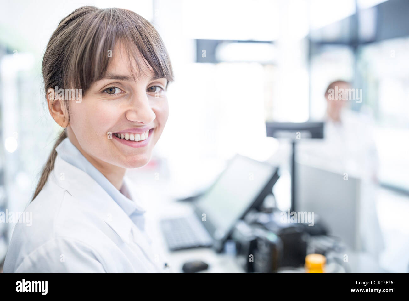 Portrait of smiling woman in lab coat Stock Photo