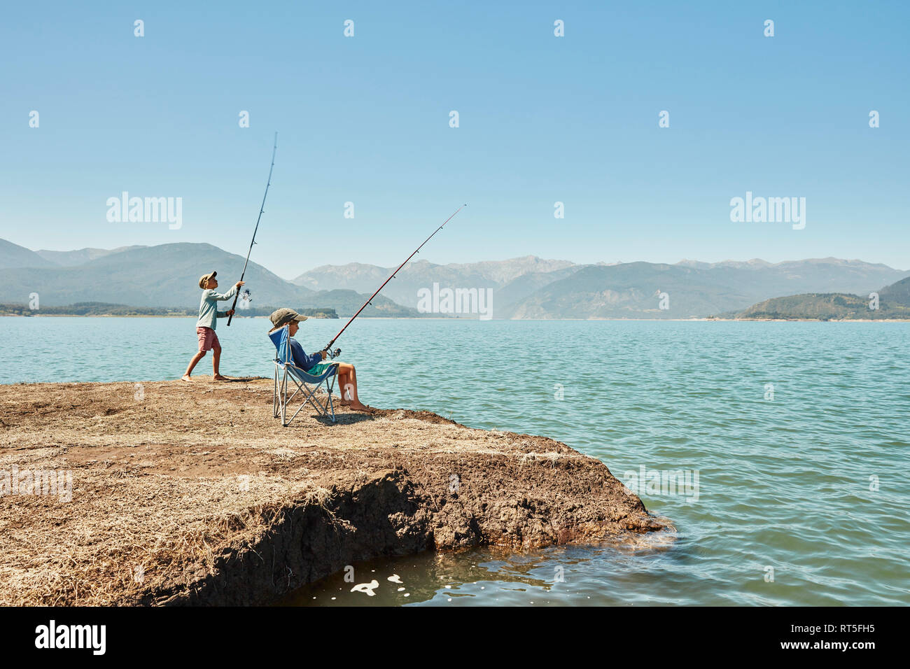 Chile, Talca, Rio Maule, two boys fishing in lake Stock Photo