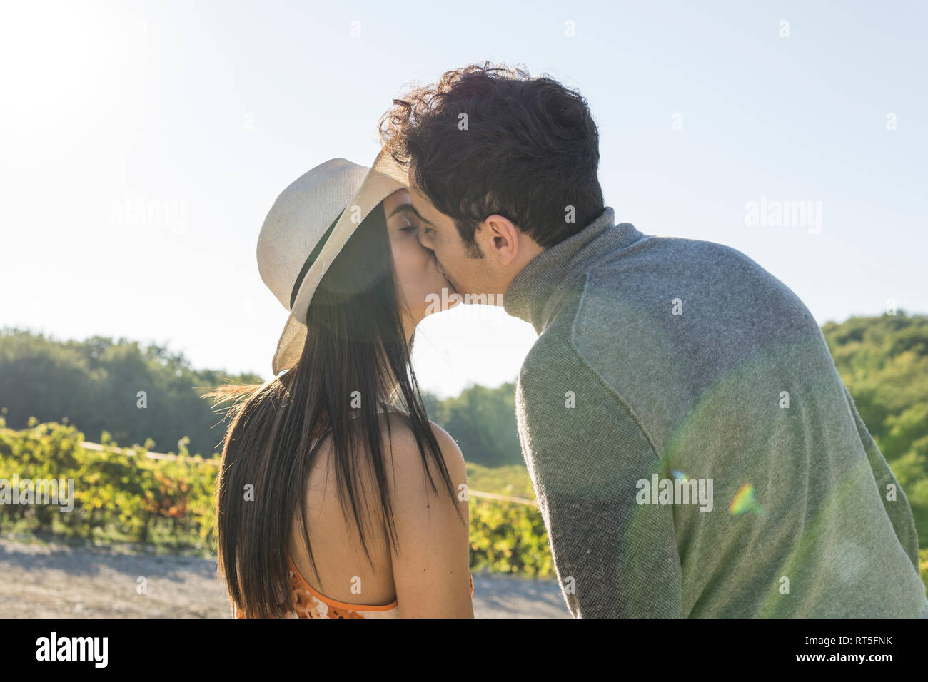 Italy, Tuscany, Siena, young couple kissing in a vineyard Stock Photo