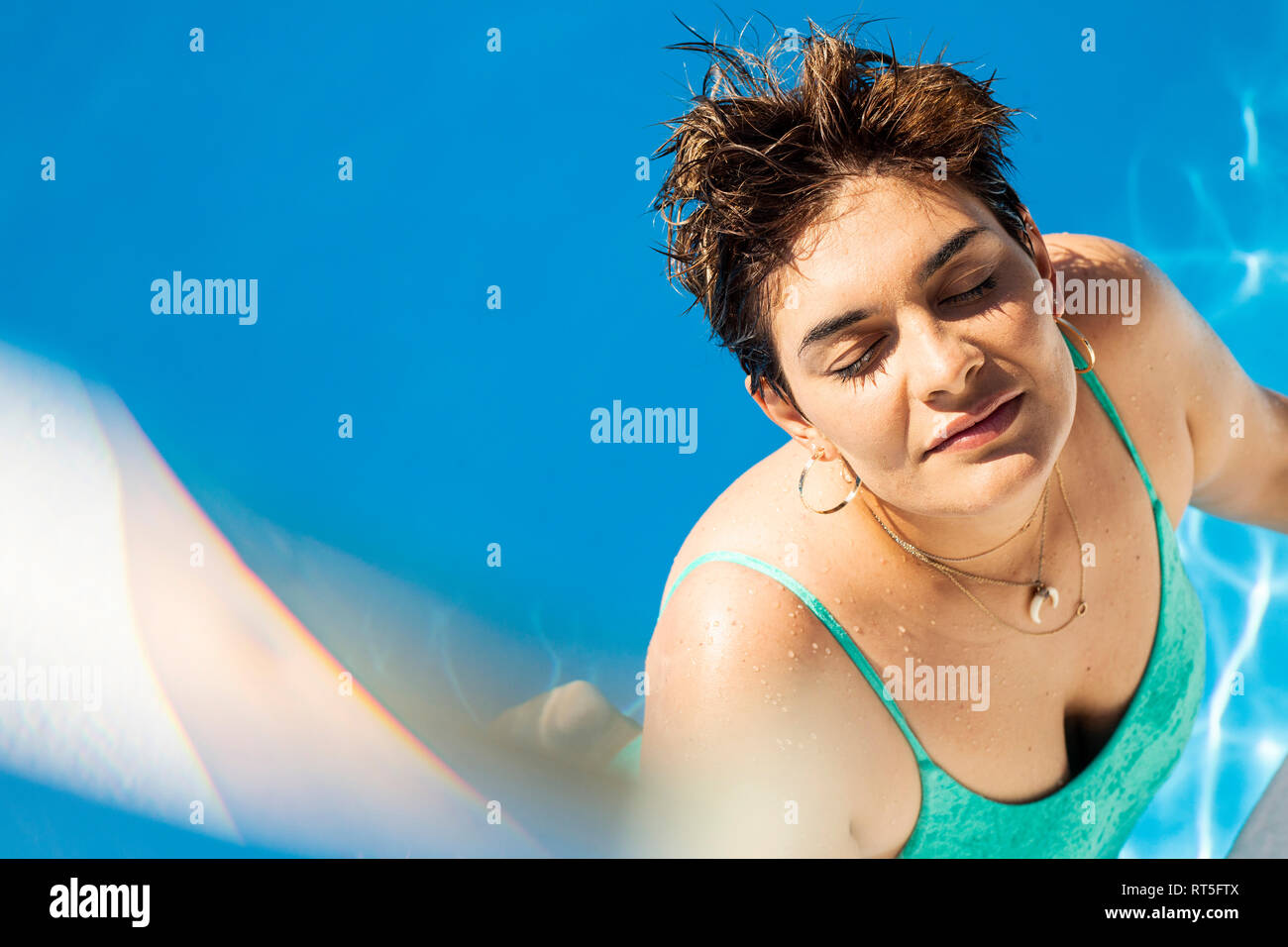 Portrait of young woman relaxing in swimming pool Stock Photo - Alamy