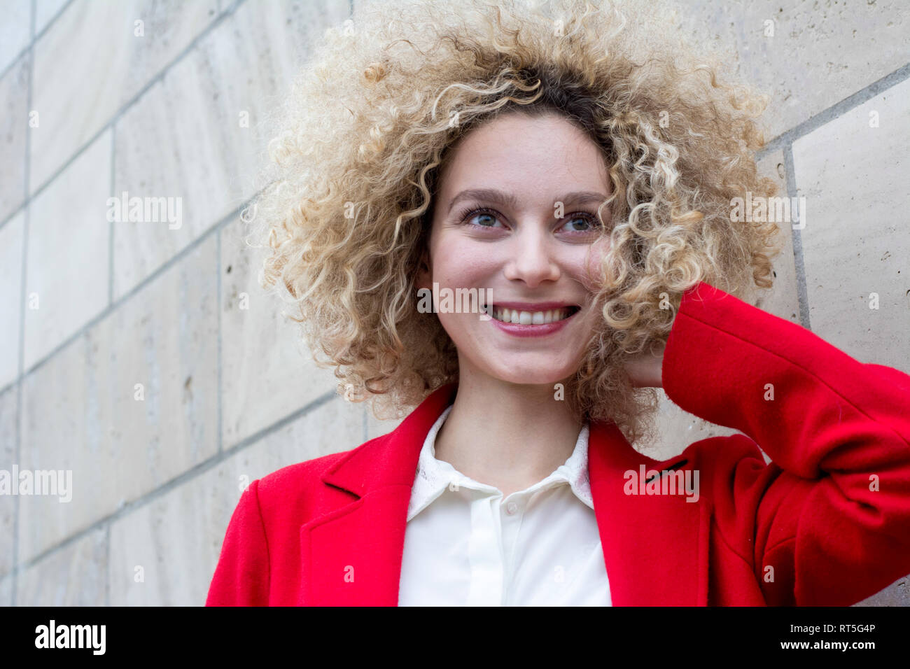 Portrait of smiling blond woman with ringlets Stock Photo