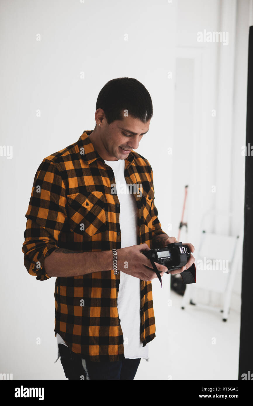 Smiling photographer looking at camera in studio Stock Photo