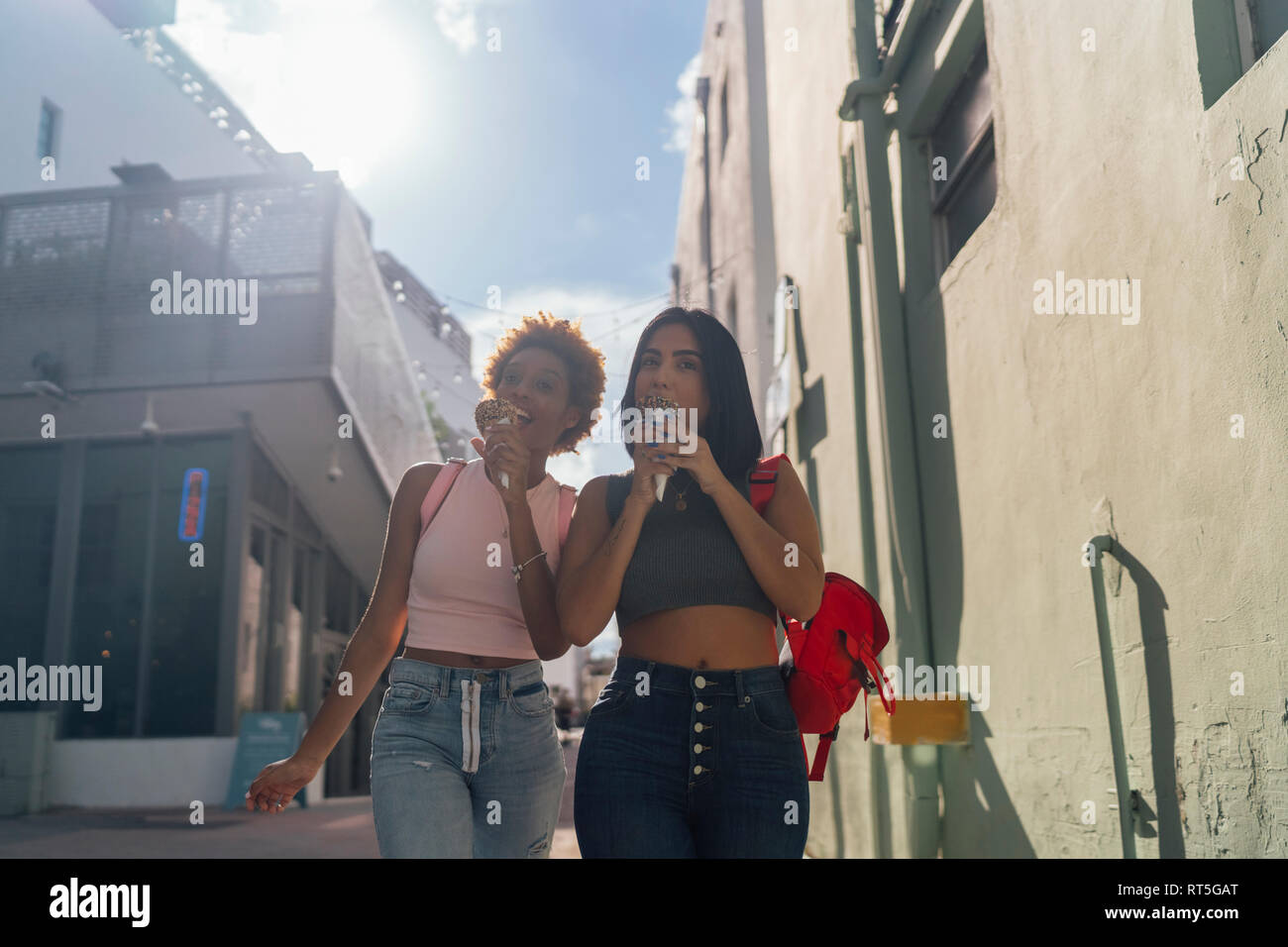 USA, Florida, Miami Beach, two female friends eating ice cream cones in