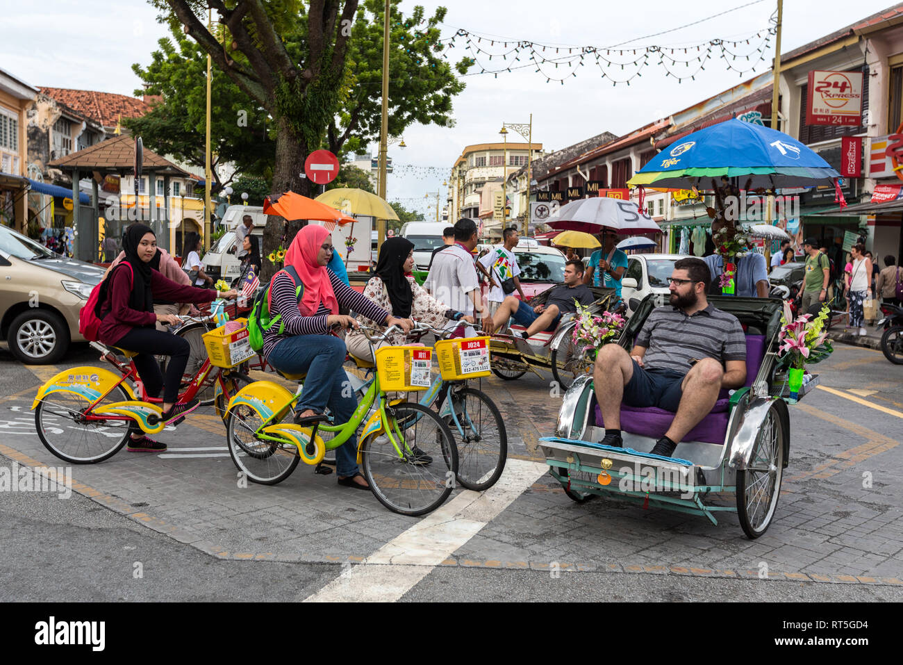 George Town, Penang, Malaysia.  Bicycles and Trishaws at a Busy Intersection. Stock Photo