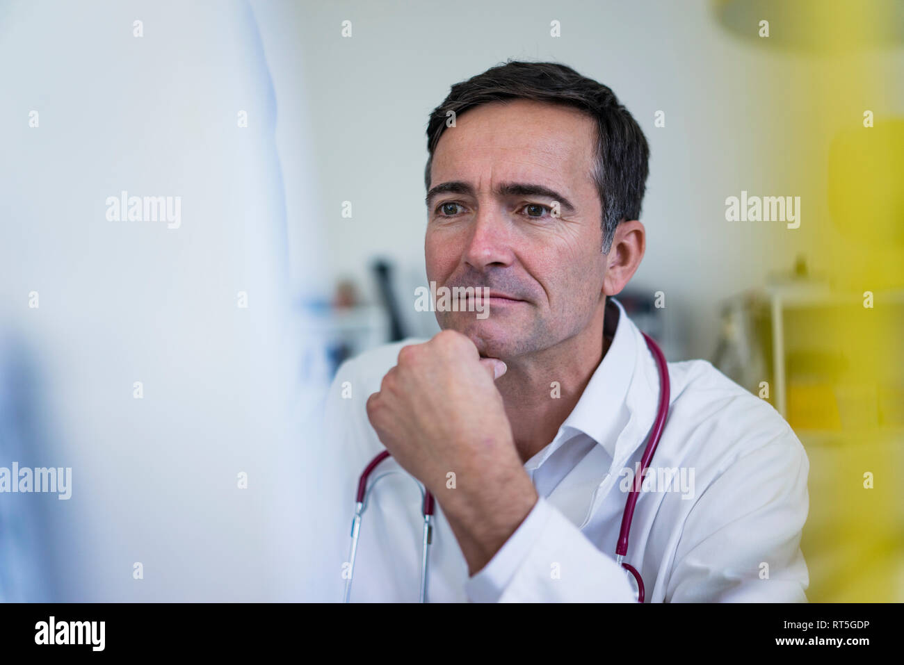 Doctor in medical practice looking at computer Stock Photo