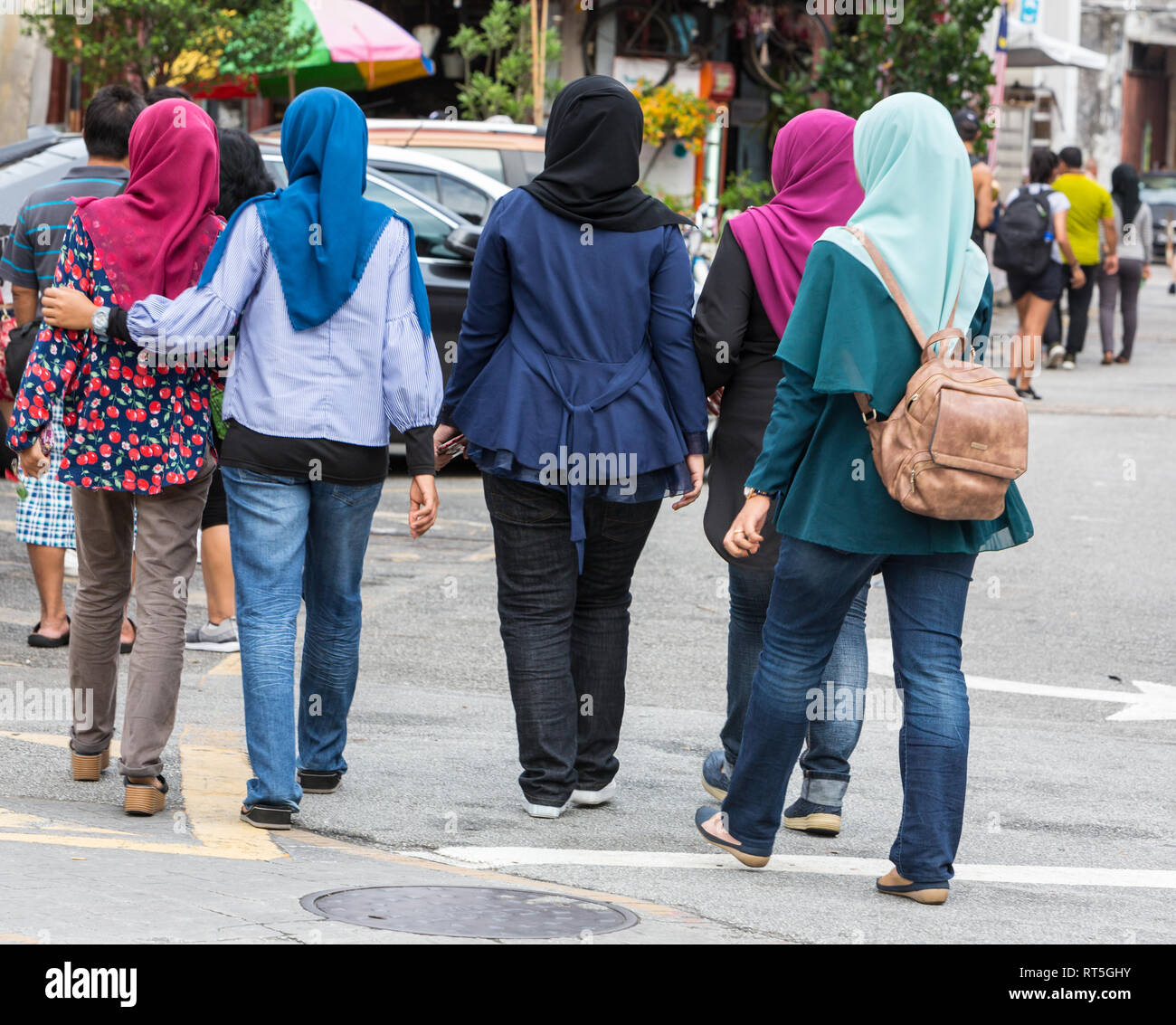 George Town, Penang, Malaysia.  Malaysian Women in Conservative Muslim Dress, with Blue Jeans. Stock Photo