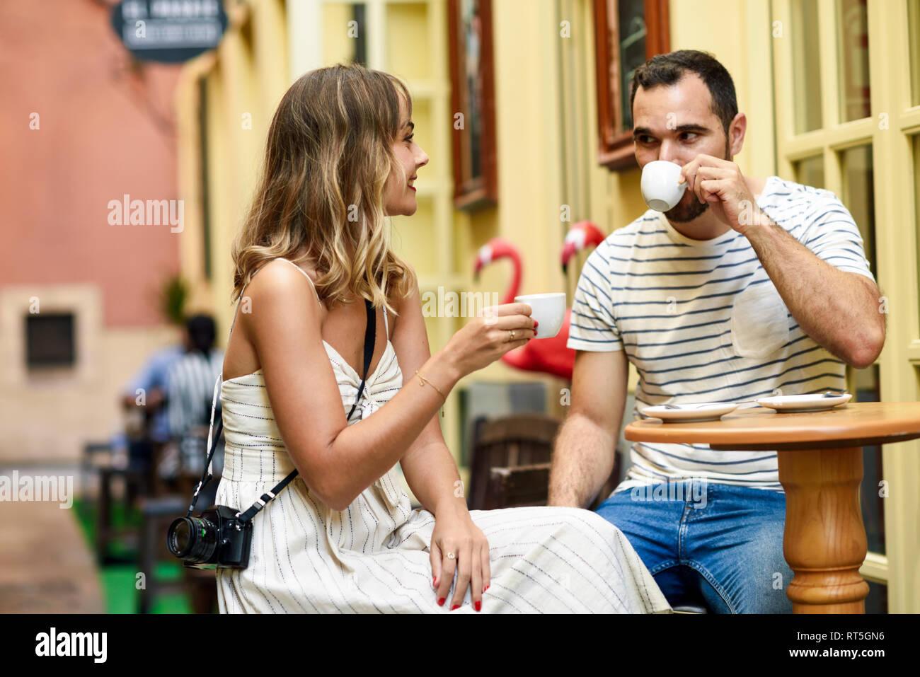 Spain, Andalusia, Malaga, couple having a coffee in an alley Stock