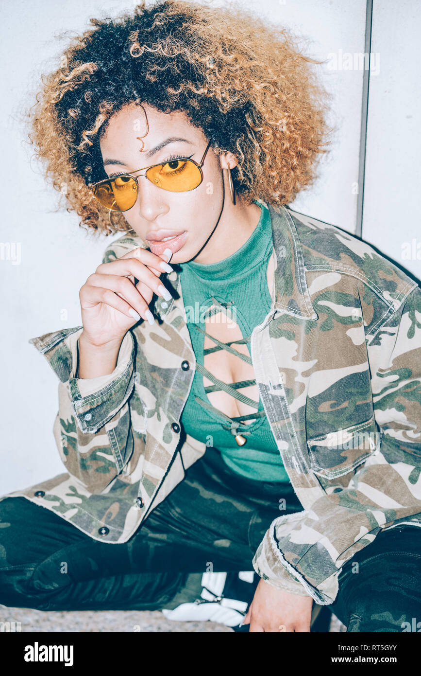 Portrait of attractive young woman wearing sunglasses Stock Photo - Alamy