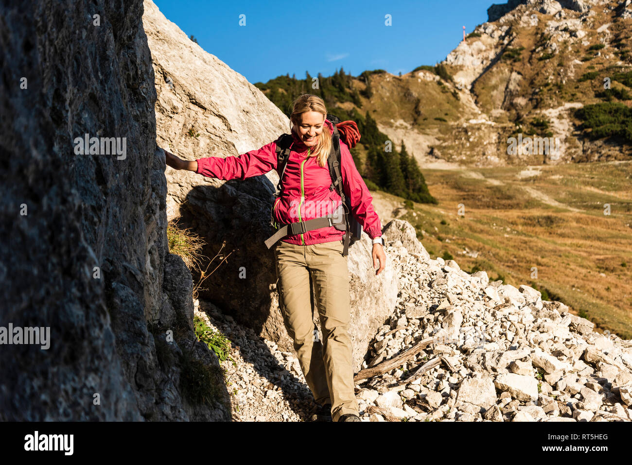 Woman mountain hiking in rocky terrain Stock Photo