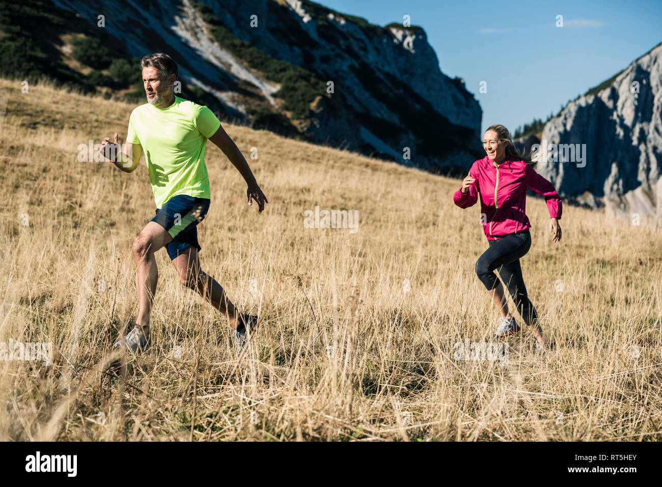 Austria, Tyrol, couple running in the mountains Stock Photo