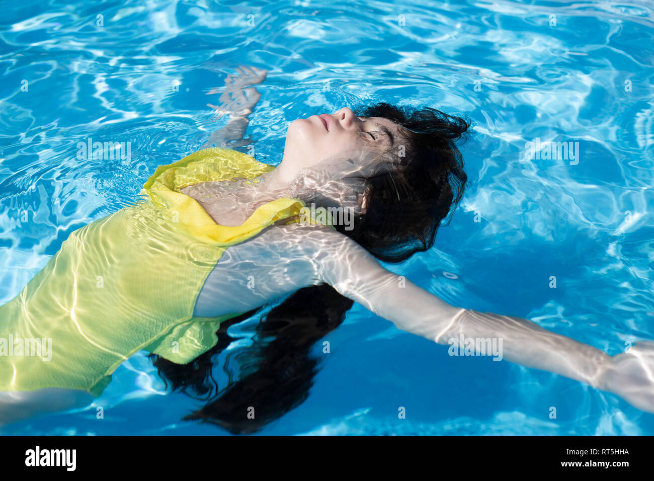 Little girl floating on water in swimming pool Stock Photo Alamy