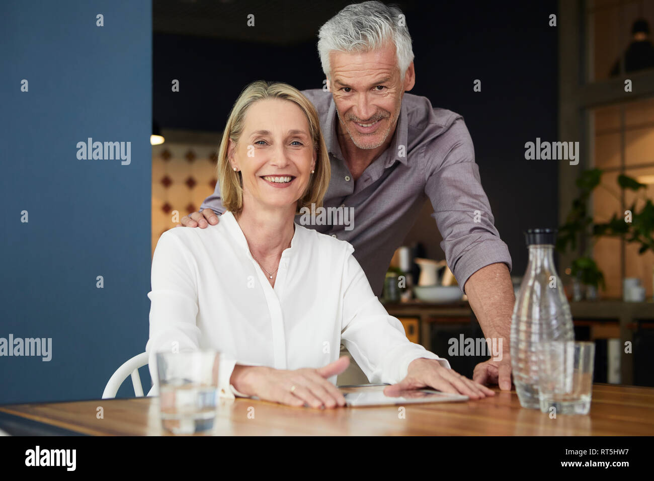 Portrait of smiling mature couple at home Stock Photo