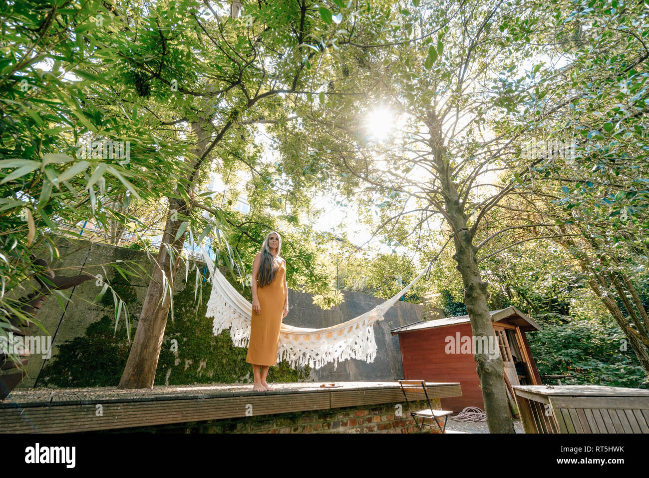 Woman relaxing in her garden Stock Photo - Alamy