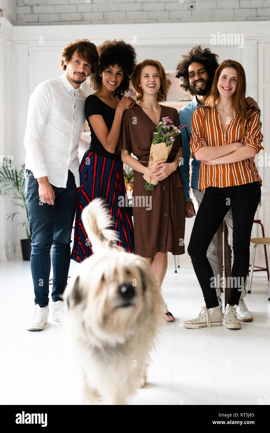 Group picture with a dog, of friends, celebrating ghe birthday og a young woman Stock Photo