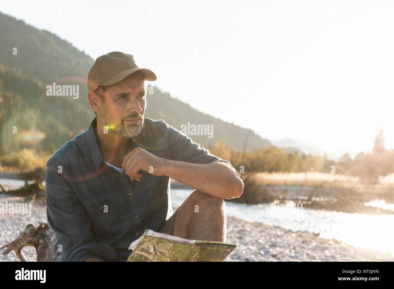 Mature man camping at riverside Stock Photo