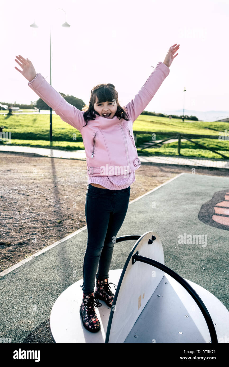 Portrait of girl wearing pink leather jacket on playground Stock Photo