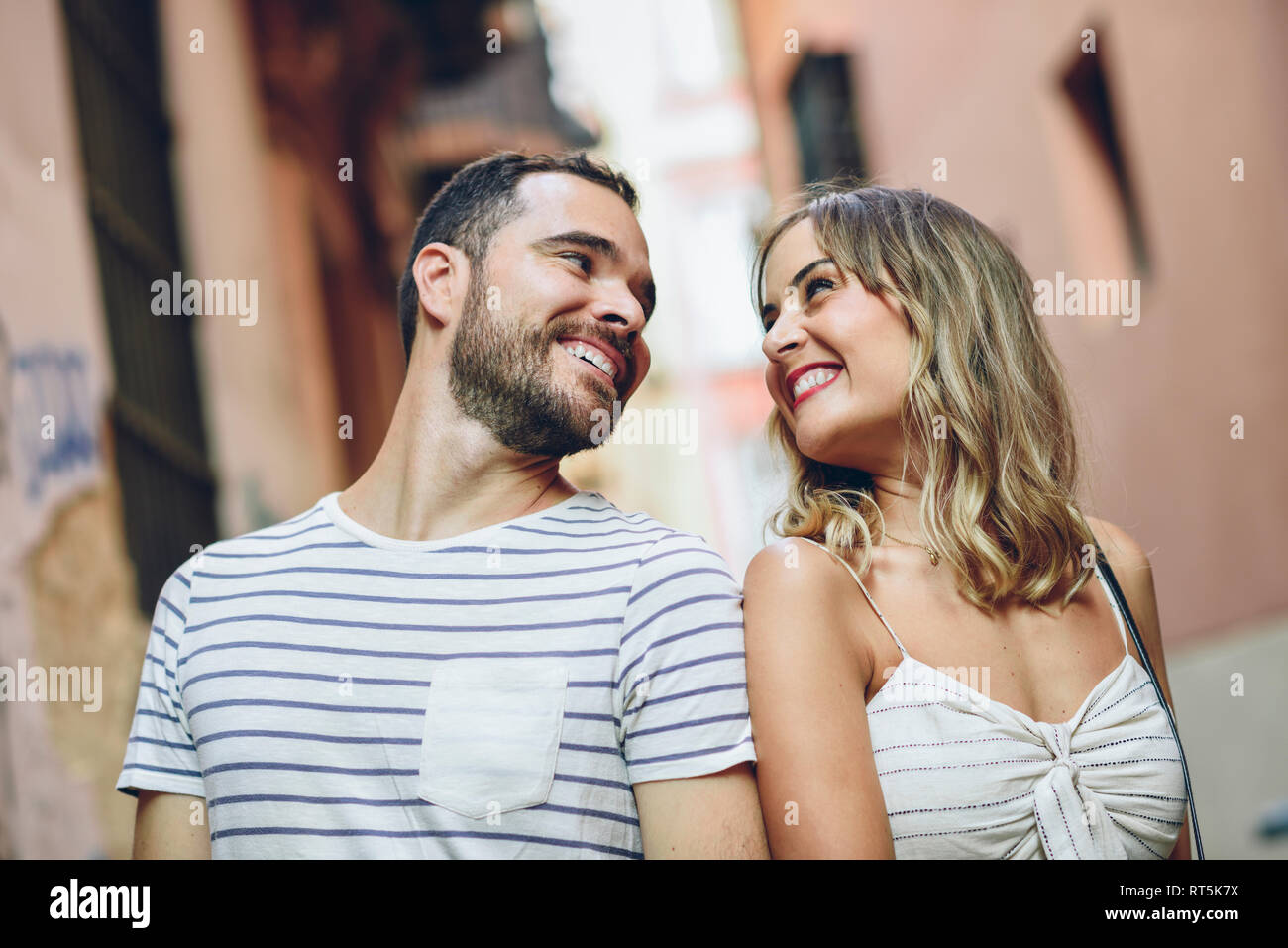 Spain, Andalusia, Malaga, happy tourist couple looking at each other in the city Stock Photo