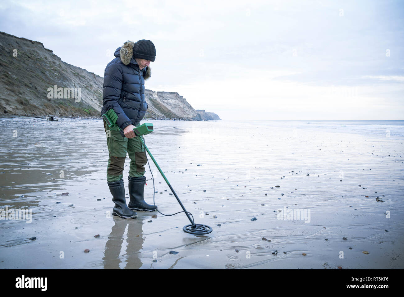 Man with metal detector at the sand beach Stock Photo Alamy